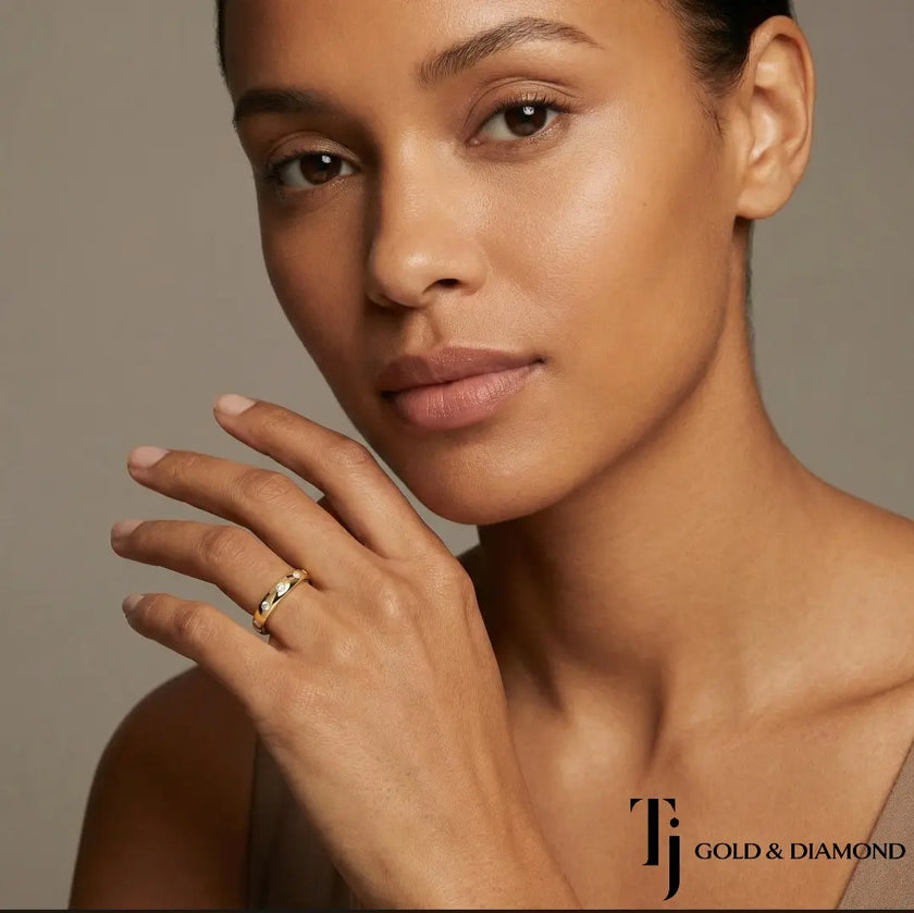 Model wearing Flush Half Eternity diamond wedding band in 18kt yellow gold, close-up lifestyle shot