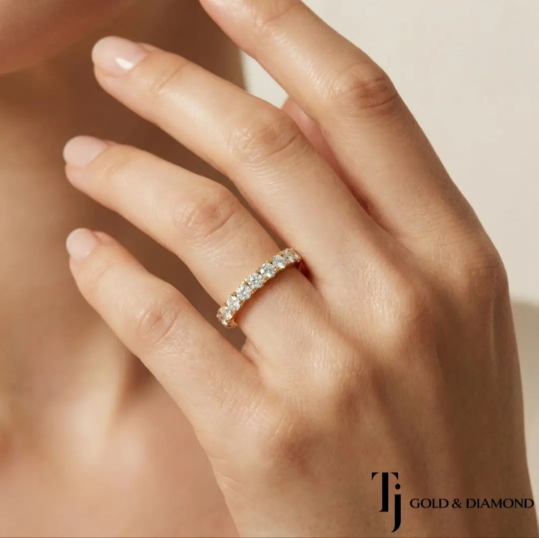 Model wearing French Pavé Half Eternity diamond wedding band in 18kt yellow gold, close-up lifestyle shot