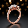Angled view of a heart cut three-stone lab-grown diamond engagement ring in 18kt rose gold with diamond shoulders