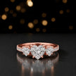 Front view of a heart cut three-stone lab-grown diamond engagement ring in 18kt rose gold with diamond shoulders