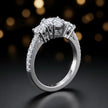 Angled view of a heart cut three-stone lab-grown diamond engagement ring in 18kt white gold with diamond shoulders