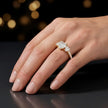Heart cut three-stone lab-grown diamond engagement ring in 18kt yellow gold with diamond shoulders worn on hand