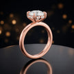 Front view of 4-claw heart cut engagement ring with hidden halo in 18kt rose gold