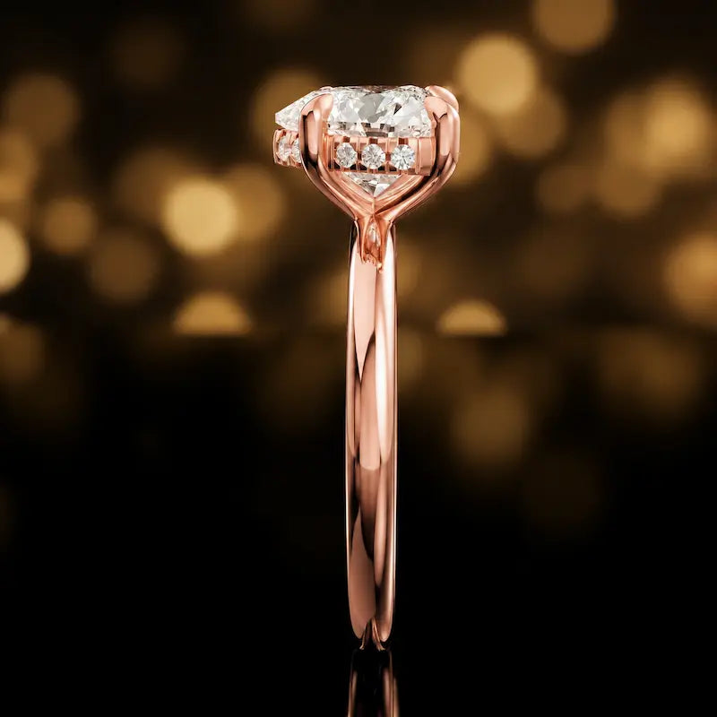Side profile of 4-claw heart cut engagement ring with hidden halo in 18kt rose gold