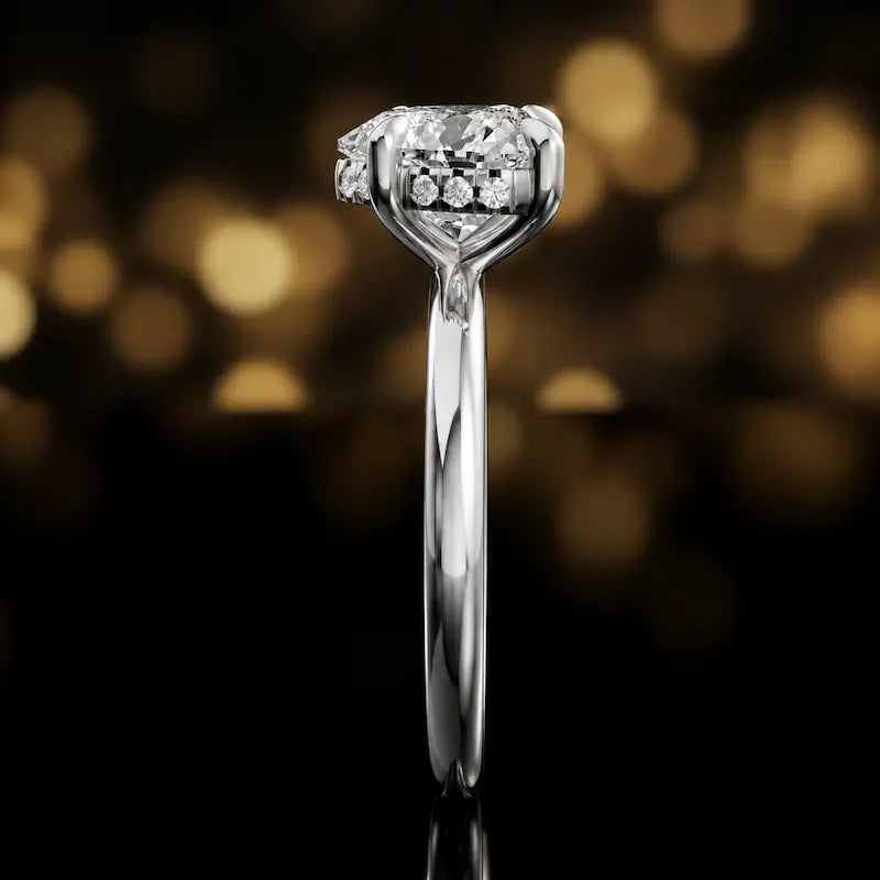 Side profile of 4-claw heart cut engagement ring with hidden halo in 18kt white gold