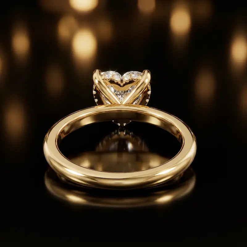 Back view of 4-claw heart cut engagement ring with hidden halo in 18kt yellow gold