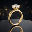Front view of 4-claw heart cut engagement ring with hidden halo in 18kt yellow gold