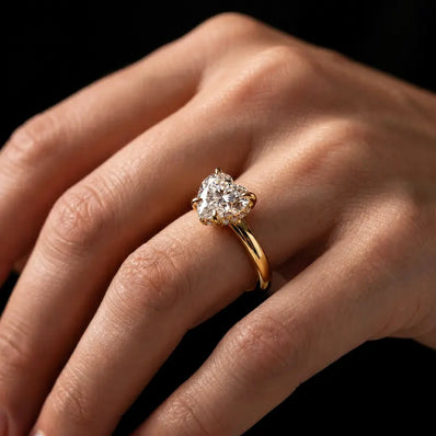 4-claw heart cut engagement ring with hidden halo in 18kt yellow gold, worn on hand