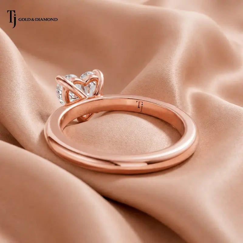 Back view of a 1.5 carat heart cut lab-grown diamond solitaire engagement ring in 18kt rose gold with a 4-claw setting