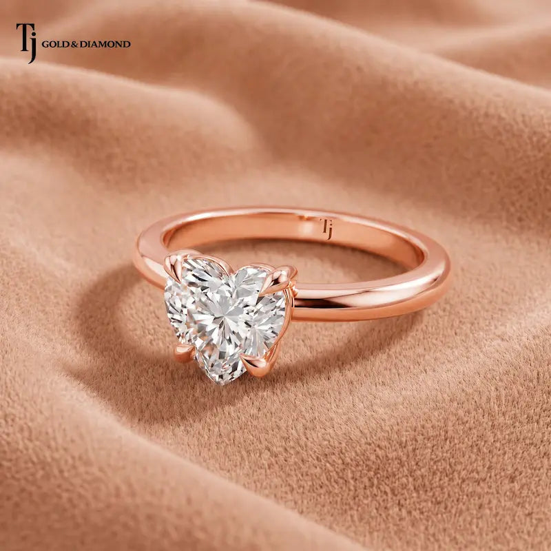 Front view of a 1.5 carat heart cut lab-grown diamond solitaire engagement ring in 18kt rose gold with a 4-claw setting