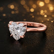 Angled side view of a 1.5 carat heart cut diamond solitaire engagement ring in an 18kt rose gold 4 claw setting by TJ Diamond