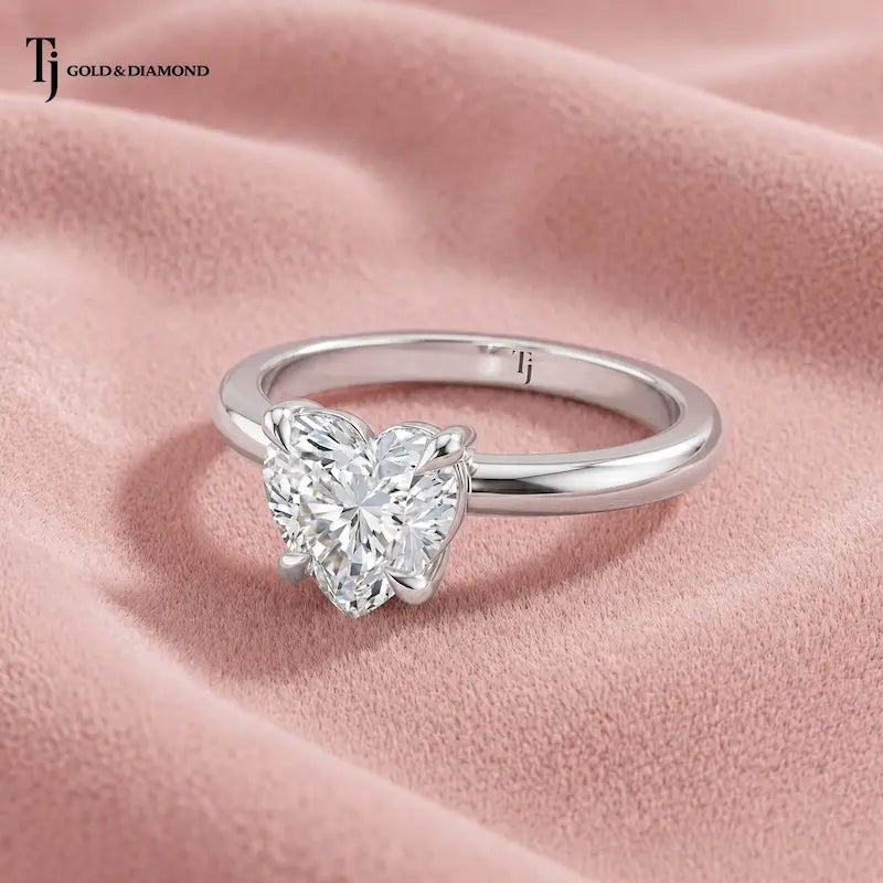 Front view of a 1.5 carat heart cut lab-grown diamond solitaire engagement ring in 18kt white gold with a 4-claw setting