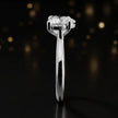 Side profile of a 1.5 carat heart cut diamond solitaire engagement ring showing the cathedral setting and 18kt white gold band by TJ Diamond