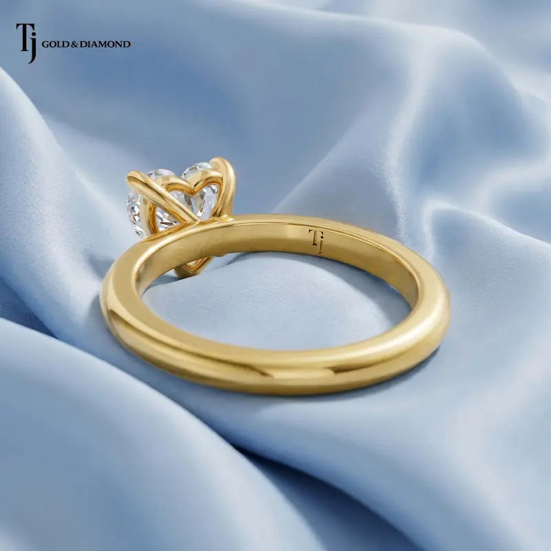 Back view of a 1.5 carat heart cut lab-grown diamond solitaire engagement ring in 18kt yellow gold with a 4-claw setting