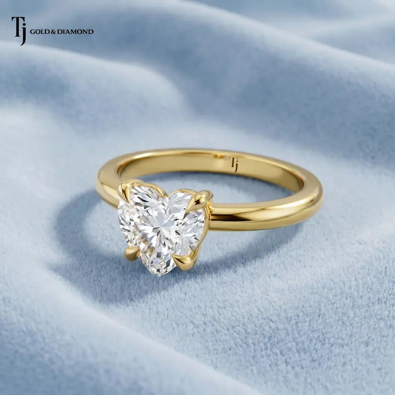 Front view of a 1.5 carat heart cut lab-grown diamond solitaire engagement ring in 18kt yellow gold with a 4-claw setting