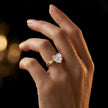 1.5 carat heart cut diamond solitaire engagement ring in an 18kt yellow gold 4 claw setting worn on a hand, by TJ Diamond