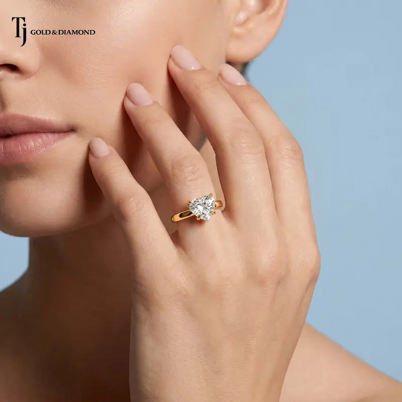 1.5 carat heart cut lab-grown diamond solitaire engagement ring in 18kt yellow gold on model