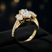 Angled view of a marquise cut three-stone lab-grown diamond engagement ring in 18kt yellow gold with diamond shoulders