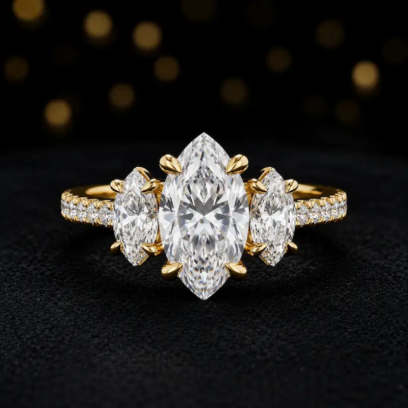 Front view of a marquise cut three-stone lab-grown diamond engagement ring in 18kt yellow gold with diamond shoulders