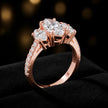 Angled view of a marquise cut three-stone lab-grown diamond engagement ring in 18kt rose gold with diamond shoulders