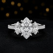 Front view of a marquise cut three-stone lab-grown diamond engagement ring in 18kt white gold with diamond shoulders