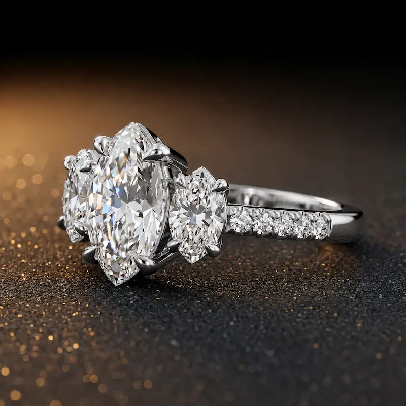 Side view of a marquise cut three-stone lab-grown diamond engagement ring in 18kt white gold with diamond shoulders