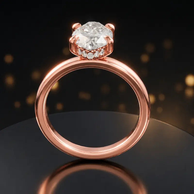 Front view of 4-claw marquise cut engagement ring with hidden halo in 18kt rose gold