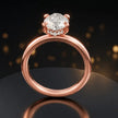 Front view of 4-claw marquise cut engagement ring with hidden halo in 18kt rose gold