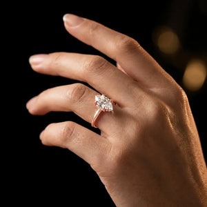 4-claw marquise cut engagement ring with hidden halo in 18kt rose gold, worn on hand