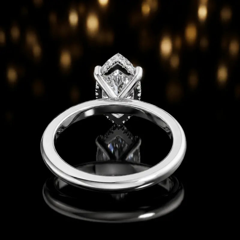 Back view of 4-claw marquise cut engagement ring with hidden halo in 18kt white gold
