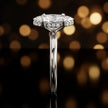 Side profile of 4-claw marquise cut engagement ring with hidden halo in 18kt white gold