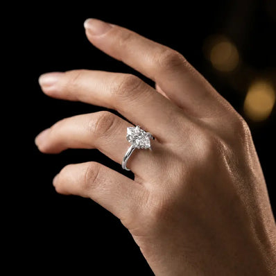 4-claw marquise cut engagement ring with hidden halo in 18kt white gold, worn on hand