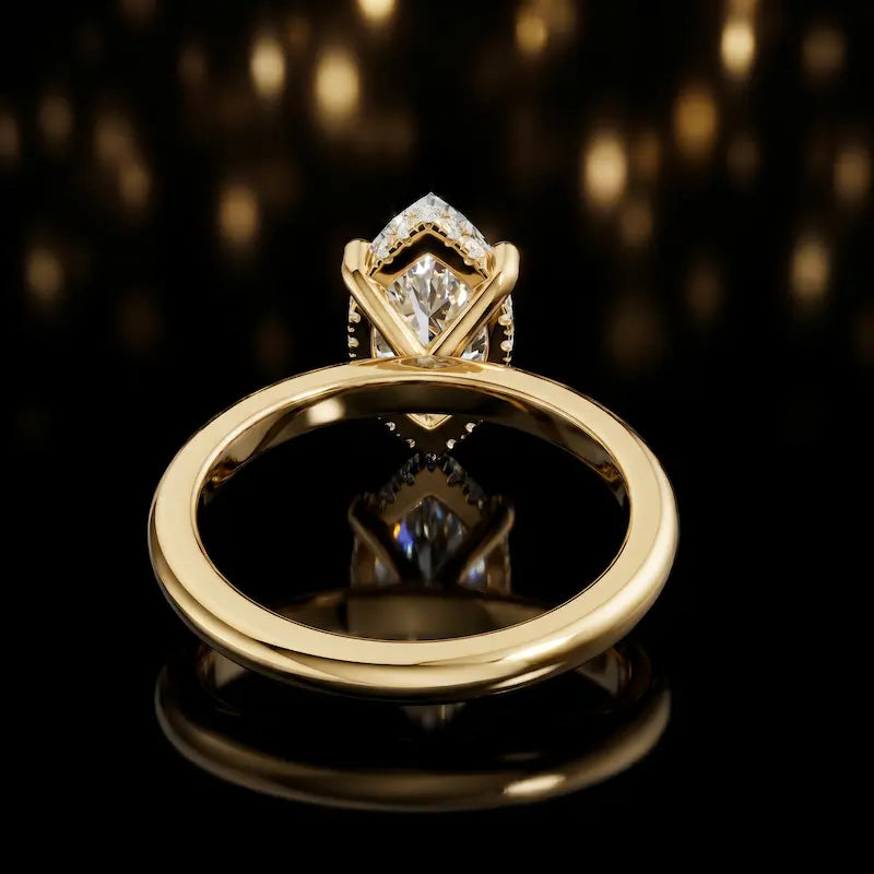 Back view of 4-claw marquise cut engagement ring with hidden halo in 18kt yellow gold