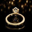 Back view of 4-claw marquise cut engagement ring with hidden halo in 18kt yellow gold