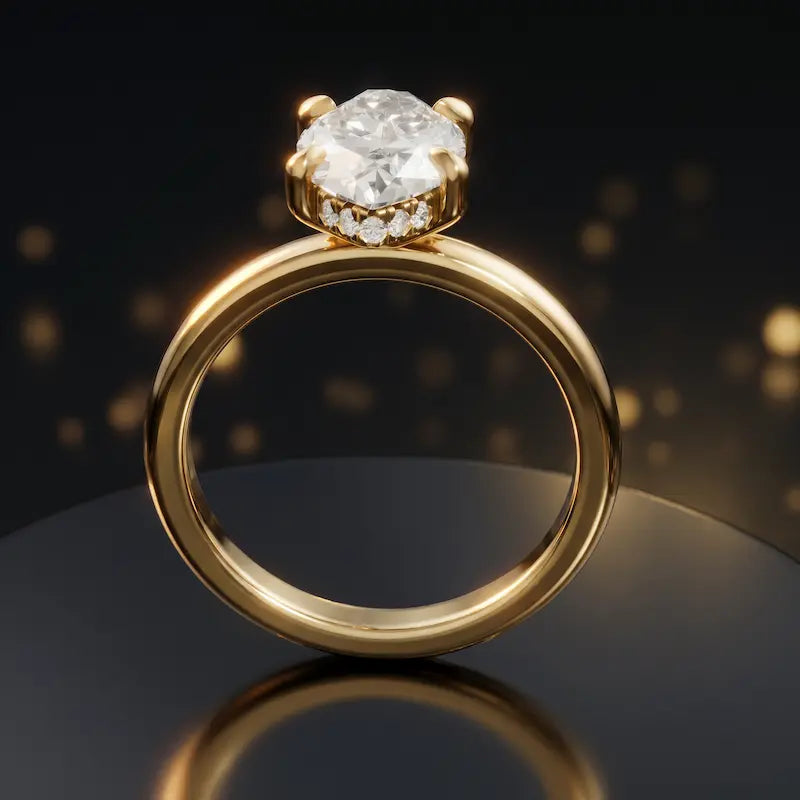 Front view of 4-claw marquise cut engagement ring with hidden halo in 18kt yellow gold