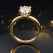Front view of 4-claw marquise cut engagement ring with hidden halo in 18kt yellow gold