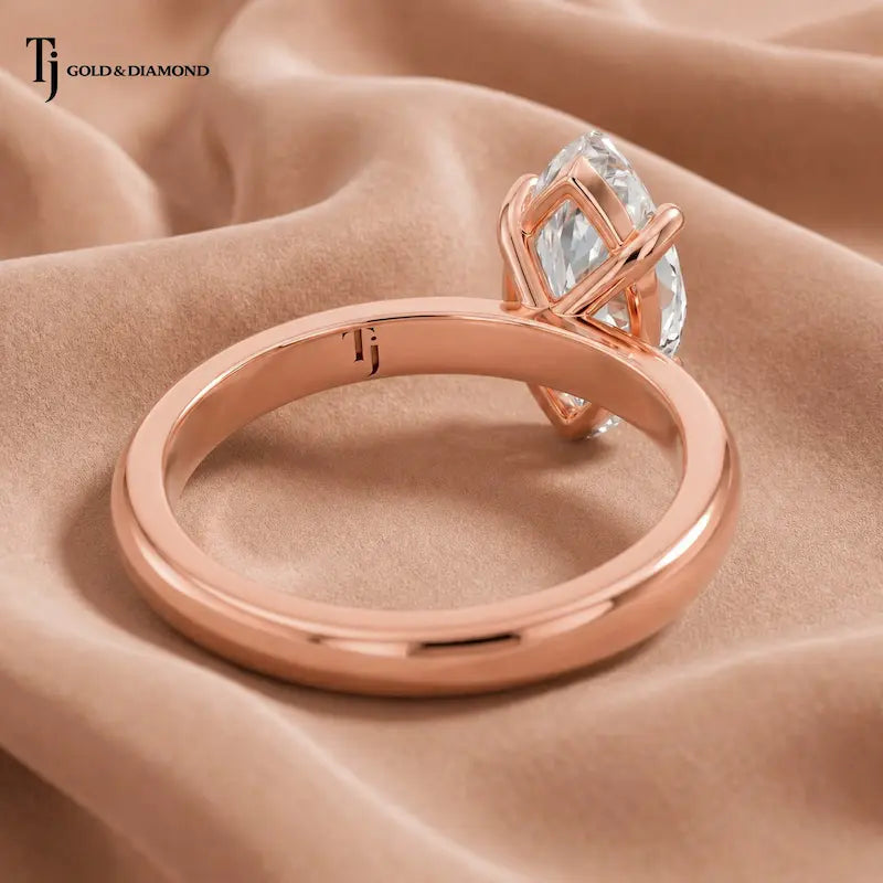 Back view of a 1.5 carat marquise cut lab-grown diamond solitaire engagement ring in 18kt rose gold with a 4-claw setting