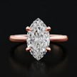 Front view of a 1.5 carat marquise cut diamond solitaire engagement ring in an 18kt rose gold 4 claw setting by TJ Diamond