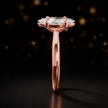 Side profile of a 1.5 carat marquise cut diamond solitaire engagement ring showing the cathedral setting and 18kt rose gold band by TJ Diamond