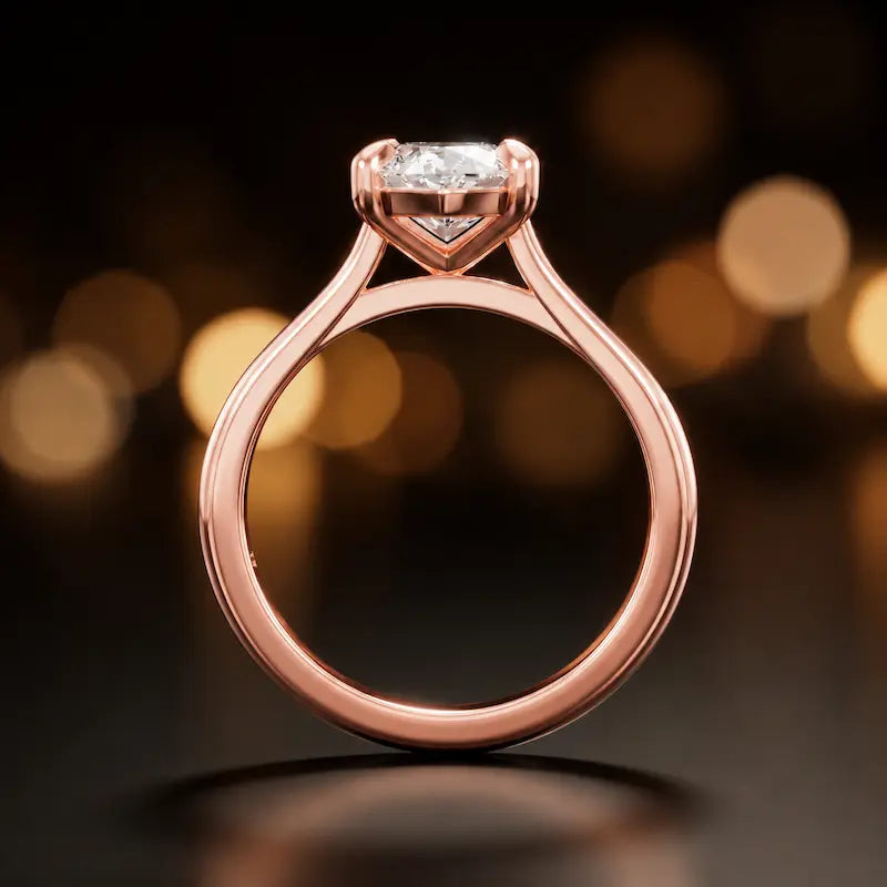 Front-on view of a 1.5 carat marquise cut diamond solitaire engagement ring showing the full 18kt rose gold band and 4 claw cathedral setting by TJ Diamond