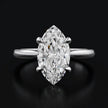 Front view of a 1.5 carat marquise cut diamond solitaire engagement ring in an 18kt white gold 4 claw setting by TJ Diamond