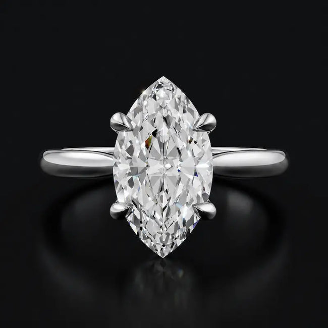 Front view of a 1.5 carat marquise cut diamond solitaire engagement ring in an 18kt white gold 4 claw setting by TJ Diamond