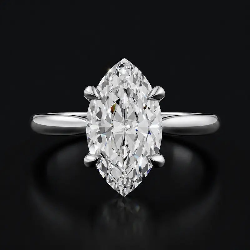 Front view of a 1.5 carat marquise cut diamond solitaire engagement ring in an 18kt white gold 4 claw setting by TJ Diamond