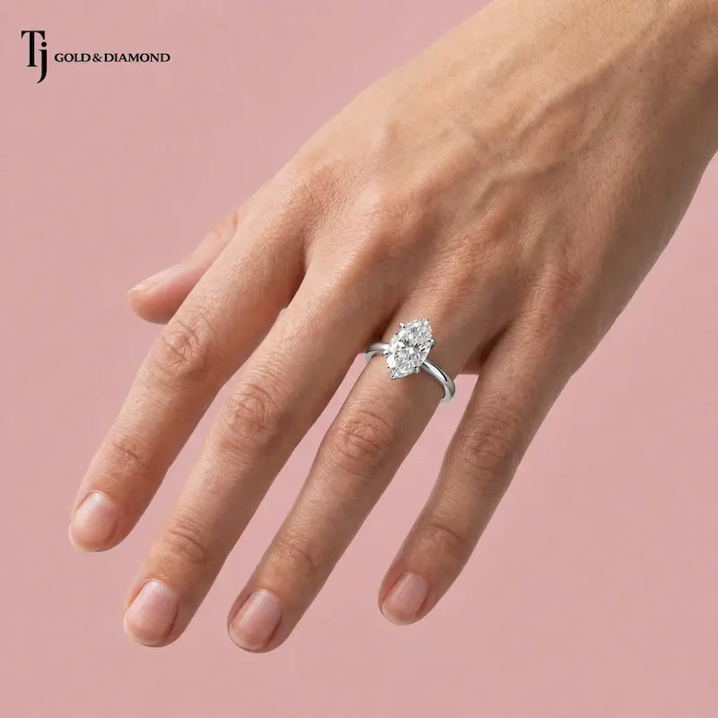 1.5 carat marquise cut lab-grown diamond solitaire engagement ring in 18kt white gold worn on hand