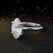 Angled side view of a 1.5 carat marquise cut diamond solitaire engagement ring in an 18kt white gold 4 claw setting by TJ Diamond