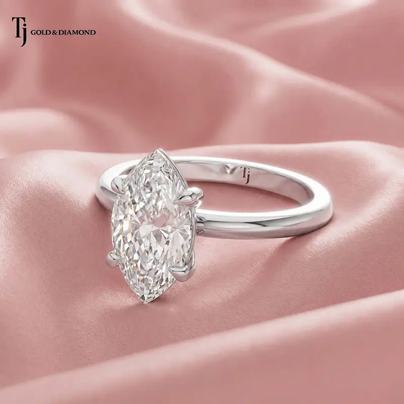 Side view of a 1.5 carat marquise cut lab-grown diamond solitaire engagement ring in 18kt white gold on satin