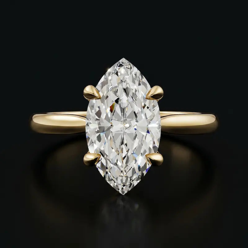 Front view of a 1.5 carat marquise cut diamond solitaire engagement ring in an 18kt yellow gold 4 claw setting by TJ Diamond