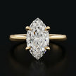 Front view of a 1.5 carat marquise cut diamond solitaire engagement ring in an 18kt yellow gold 4 claw setting by TJ Diamond