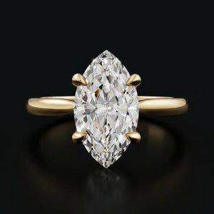 Front view of a 1.5 carat marquise cut diamond solitaire engagement ring in an 18kt yellow gold 4 claw setting by TJ Diamond