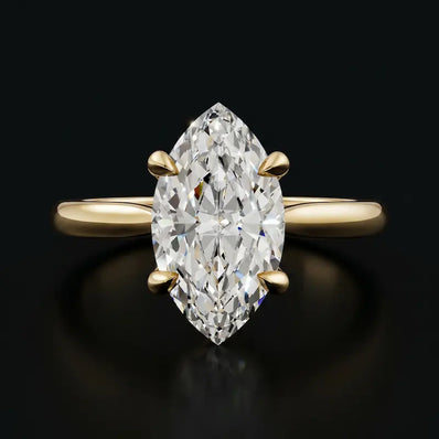 Front view of a 1.5 carat marquise cut diamond solitaire engagement ring in an 18kt yellow gold 4 claw setting by TJ Diamond